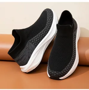 Detailed macro shot of breathable black knit sock sneakers with thick white soles.