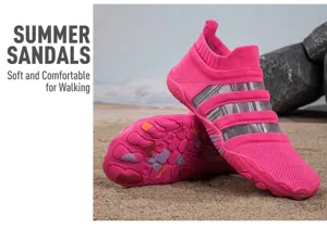 Pink mesh barefoot shoes for beach and swimming shown in a natural sand setting