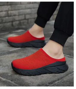 Detailed view of breathable red mesh mule sneakers with thick black platform soles