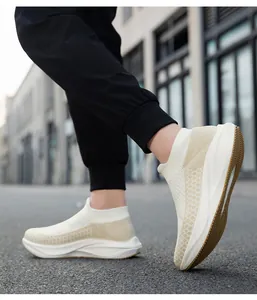 Side view detail of breathable white fly-knit sock sneakers worn for stylish urban walking