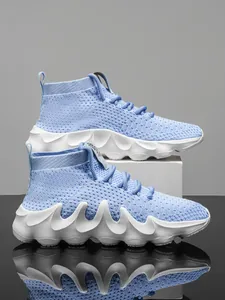 Profile view of light blue breathable flyknit running sock sneakers with wavy white soles