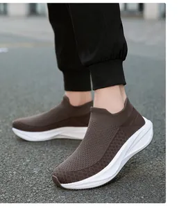 Detailed outdoor shot of brown breathable fly-knit slip-on sock sneakers for men