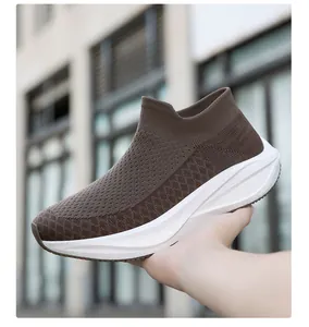 Detail shot of breathable brown knitted slip-on sock sneaker with thick white sole