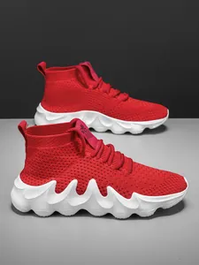 Detailed view of red breathable fly-knit sock sneakers with chunky white wavy soles