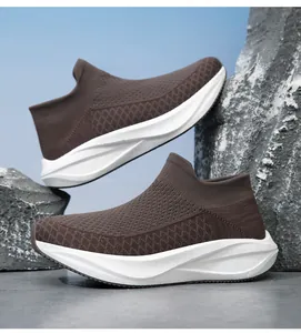 Detailed macro view of brown breathable knit sock sneakers featuring thick white comfort soles