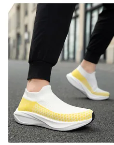 Action shot of breathable yellow and white knit sock sneakers for casual wear