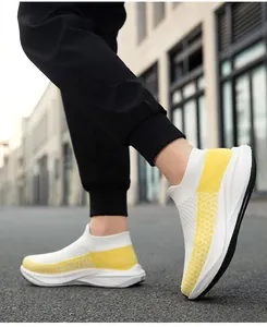 Close-up side view showing the breathable white and yellow fly-knit sock sneakers