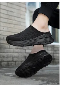 Close-up side view of black breathable mesh mules on feet featuring thick non-slip soles