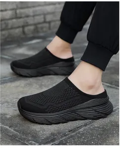 Side view of black breathable mesh slip-on clogs with thick platform soles for outdoor casual wear.