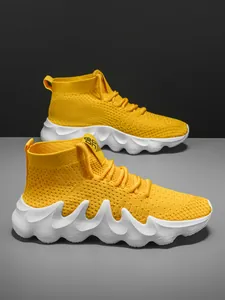 Vibrant yellow breathable knit running sneakers with chunky white wavy soles