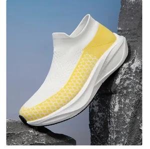 Side view detail of breathable white fly-knit sneaker featuring yellow pattern design