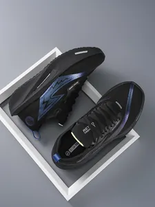 Vista dall'alto di scarpe da corsa in mesh nero traspirante da uomo con dettagli blu