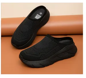 Detail shot of breathable black mesh knit mule sneakers with thick ridged sole for comfort