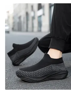 Close-up of breathable black fly-knit sock sneakers with diamond woven pattern details
