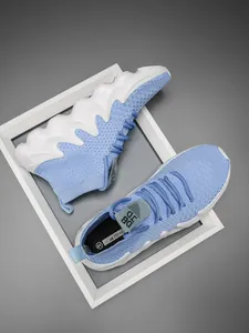 Close-up view of light blue knitted sock sneakers with white wavy soles in detail