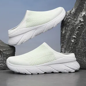 Breathable mesh outdoor mules with thick slip-resistant sole in white and mint green.