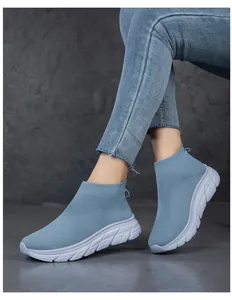 Modische hellblaue Flyknit-Sneaker zum Hineinschlüpfen, von einem Model getragen.