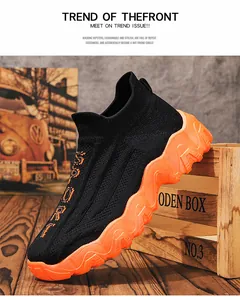Seitenansicht atmungsaktiver schwarzer Strick-Sneaker mit oranger Plateausohle