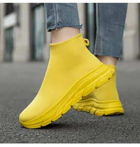 Nahaufnahme von gelben, atmungsaktiven Fly-Knit-Socken-Sneakern für Outdoor-Laufen