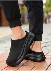 Close-up view of black knit mule sneakers for men featuring a thick non-slip platform sole