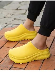 Detailed view of yellow thick-soled knit slip-on shoes for men in a casual outdoor setting.