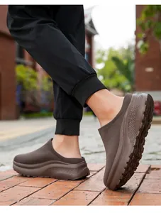 Detailed side view of men's brown platform knitted slip-on casual mules outdoors