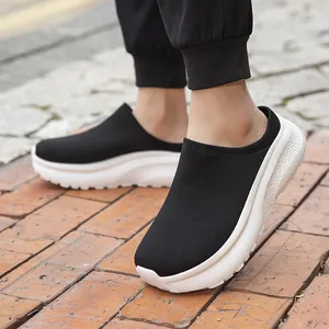 Men's black knit sock mules featuring thick white soles and comfortable slip-on design