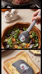 Halloween ghost themed silicone spatula spreading butter on toast in detailed close-up view