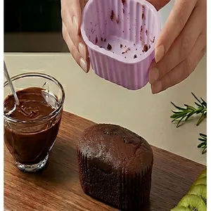 Detail showing a purple oval silicone cake mold being used for a chocolate dessert