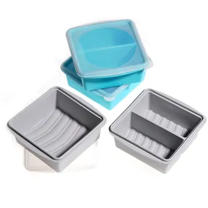 Silicone freezer storage containers with lids and measurement marks for food portioning.