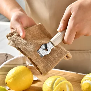 Stainless steel lemon zester and orange peeler with ergonomic handle for kitchen use.