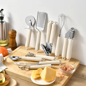 Uitgebreide 9-delige roestvrijstalen keukengerei set met crème geribbelde handvatten