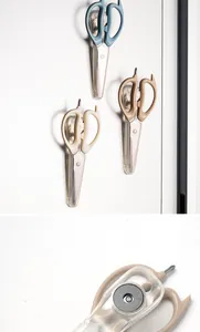 Detail of magnetic base on stainless steel kitchen scissors with protective sleeve