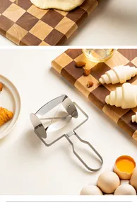 Detail view of a professional stainless steel croissant cutter roller in a kitchen scene.