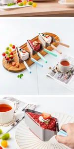 Close-up of stainless steel triangular cake lifter holding a red velvet cake slice
