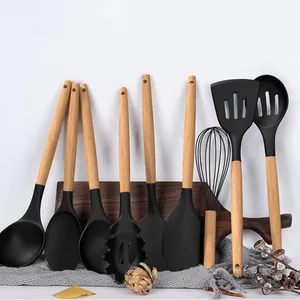 Detailed display of black silicone kitchen utensils with natural wooden handle grips