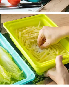 Close-up detail of a bright lime green plastic drain basket filled with sliced potatoes