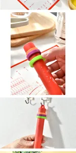 Detail view of red silicone rolling pin showing adjustable thickness spacer rings