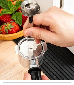 Close-up view of stainless steel dual-purpose coffee scoop tamping espresso powder