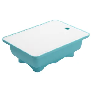 Blue and white outdoor drain basket with integrated cutting board lid for camping