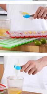 Detailed view of long strip ice cubes with lemon slices and blue silicone ice tongs