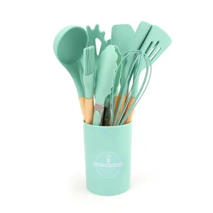 Professional mint green silicone cooking utensil set with wooden handles and storage bucket.
