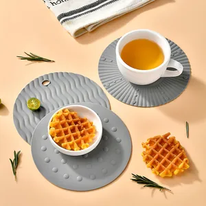 Set of 3 heat-resistant grey round silicone coasters with textured non-slip surface