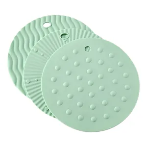Heat-resistant mint green silicone trivets with diverse textures for table protection