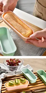 Details of rectangular silicone cake molds with freshly baked cheesecake on a wooden board