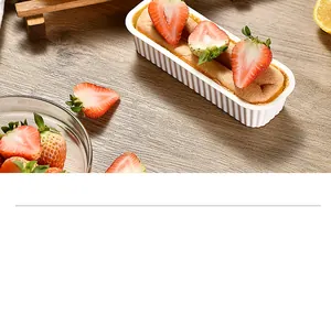 Close-up of a rectangular white silicone baking mold with fresh strawberry sponge cake