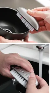 Detail of a multi-functional nylon cleaning brush in use cleaning a kitchen bowl