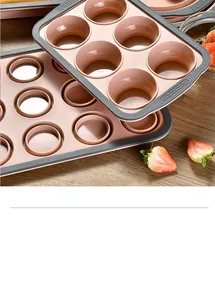 Stackable pink silicone muffin pans with gray trim presented on a wooden table.