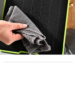 Close-up of cleaning a multifunctional aluminum alloy defrosting cutting board