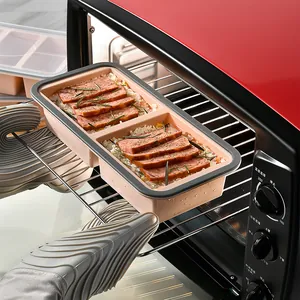 Heat-resistant two-compartment silicone food storage box being used in a red toaster oven